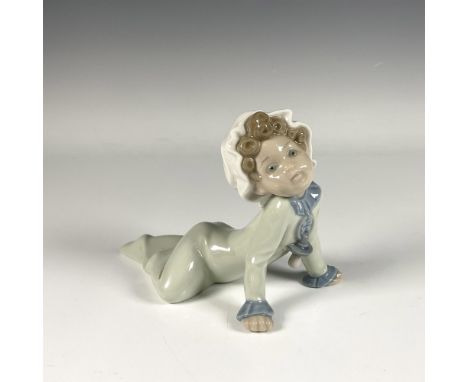 Adorable glossy figure of a baby with curly hair sitting on the floor in serene green and blue pastel tones. Lladro backstamp