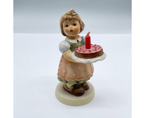 This sweet porcelain figure doubles as a cake topper. It features a girl holding a cake with a small hole to fit a small cand