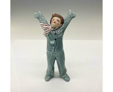 A rare figure modeled as a boy with this arms outstretched, wearing a blue suit and red and white scarf. Florence Ceramics ba