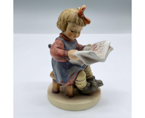 Adorable porcelain seated girl with a red bow, reading a news paper. Marked Goebel 418. Issued: 1981Dimensions: 3.5"L x 3"W x