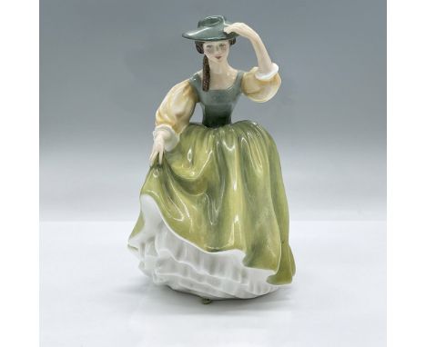 This glossy figural is part of the Peggy Davies Classic Series. Colored in variations of green with yellow golden sleeves. Ro