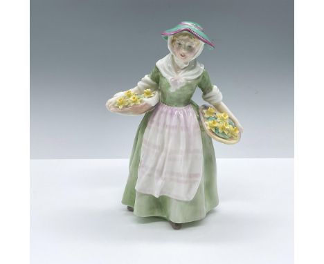 Hand decorated and hand painted figure of a blonde woman holding two large baskets filled with yellow daffodils. Green, pink 