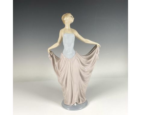 Beautiful glossy porcelain figure of a woman in an elegant dancing pose, featuring a serene pastel tones. Lladro backstamp. A