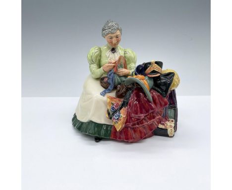 Hand decorated and hand painted figure of a seated elderly woman with a pile of clothes and hats. Royal Doulton backstamp. Ar