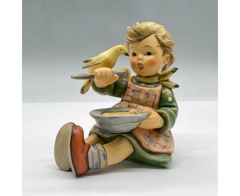 An adorable porcelain figure of a seated girl eating porridge with a bird perched on her arm. Marked Goebel First Issue 2002.