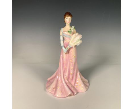 Glossy figure modeled after the actresses from the 1800s to early 1900s, dressed in a long pink gown and carrying a bouquet. 