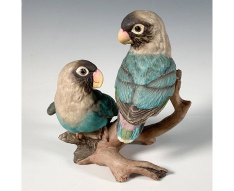 A lovely hand painted bisque porcelain figure of two blue birds perched on a branch, gazing at each other. Boehm backstamp. I