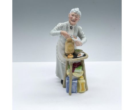 Hand decorated figure of an elderly shopkeeper pouring toffee in a paper cone packaging. Royal Doulton backstamp. Artist: Mar