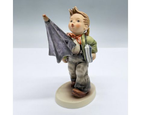 Porcelain figure of a small boy carrying a backpack, books and an umbrella. Marked Goebel Hummel 420. Issued: 1981Dimensions: