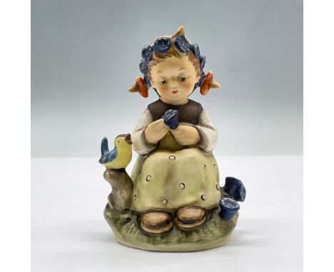 Features a precious porcelain girl with pig tails and a blue flower crown, holding a blue flower while a small bird chirps be