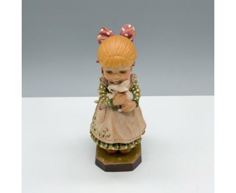 Limited edition hand carved figure of a young girl with a bow in her hair as she carries and hugs her rabbit. Anri and Sarah 