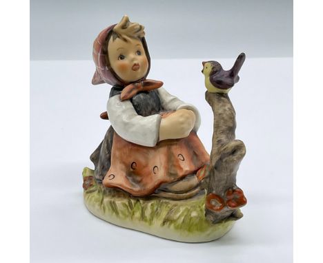 A tender porcelain figure of a seated girl singing with along with a bird. Marked Goebel 414. Issued: 1979Dimensions: 4.25"L 