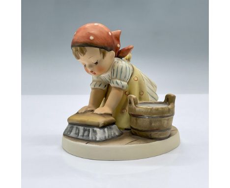 A cute porcelain figure of a girl scrubbing the floor with a large brush next to a pail of water. Marked Goebel 363. Issued: 