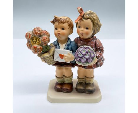 This porcelain figurine features a cute boy and girl carrying flowers and a love note. Marked Goebel Hummel 416. Issued: 1980