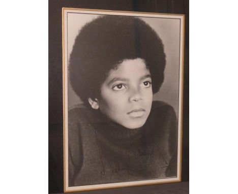 Early Michael Jackson black and white photograph signed framed and mounted. 35cms x 26cms 