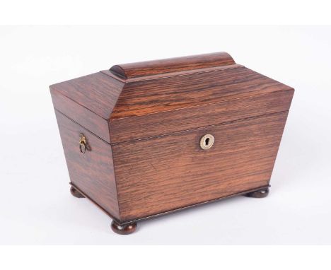 A 19th Century rosewood sarcophagus shaped tea caddy with brass mask handles, 25 x 17cms high.