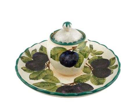A Wemyss pottery inkwell stand, circular, c.1900, with plum decoration, glass liner to the inkwell, impressed Wemyss mark and