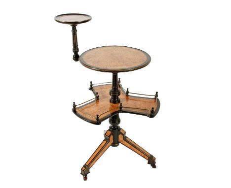 An unusual Victorian amboyna and ebonized revolving tripod book stand, c.1880, the circular top with an ebonised and gilt edg
