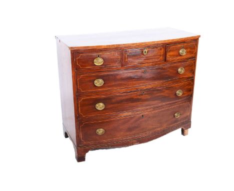 A George III mahogany and boxwood strung bowfront chest of drawers, three short and three long graduated drawers on bracket f