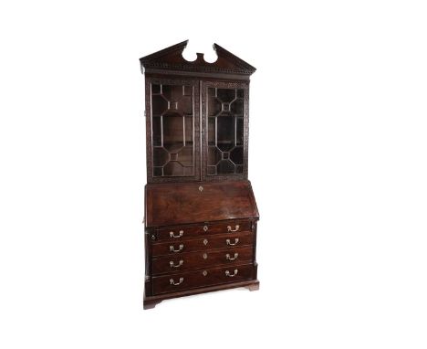 A handsome mid-18th Century mahogany bureau bookcase, the architectural pediment with dentil edge, above a frieze and pair of
