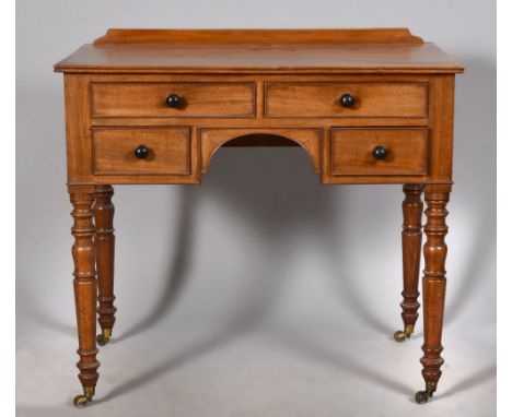 A mid 19c mahogany kneehole side table of rectangular form with fluted edge, having a shallow back board, with kneehole under