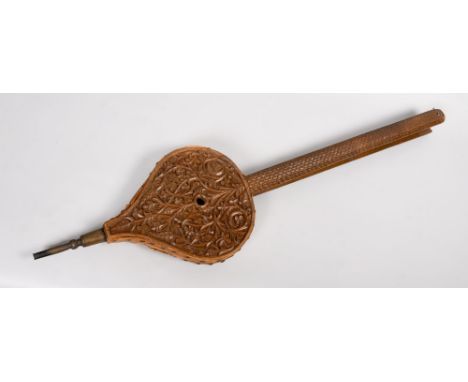 A pair of 19c long handled fire bellows, the handles scale carved, the bellows foliate carved, 37in l.