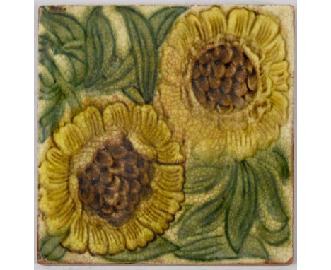 A William de Morgan red clay glazed tile with sunflower design, the reverse with impressed mark for Patent Agricultural Potte