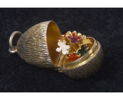 A Stuart Devlin silver gilt pendant egg opening to reveal a bouquet of coloured enamel flowers, 1in l overall.