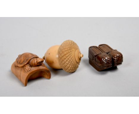 A group of three items  including a turned nut acorn thimble holder, an Oriental pair of shoes netsuke and a turtle and tunne
