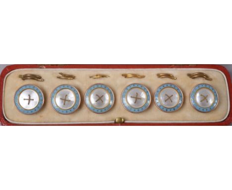 A boxed set of six gilt metal mother of pearl and enamel studs.