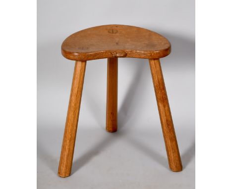 A Mouseman carved oak kidney shaped stool supported on three splayed facet carved legs, 14in w, 17.75in h.