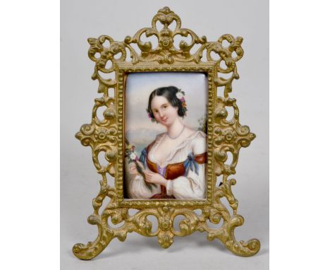 A 19c miniature painting on porcelain panel depicting a lady with flowers in her hair and holding a nosegay, in gilt metal ea