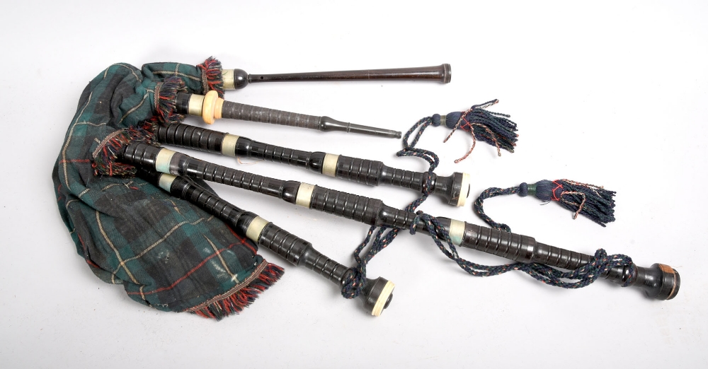 A set of Henry Starck bagpipes with turned ebony drones, a hide bag in ...