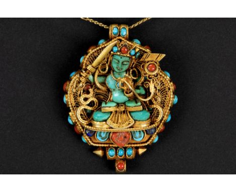 Tibeto-Nepalese ghau in gold on silver with turquoise, lapis lazuli and coral and with the depiction of Manjushri (with the s