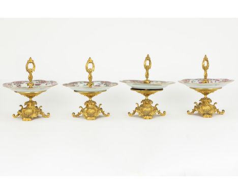 two pairs of antique tazzas each with an 18th Cent. Chinese plate with 'Famille Rose' decor and with a mounting in gilded bro