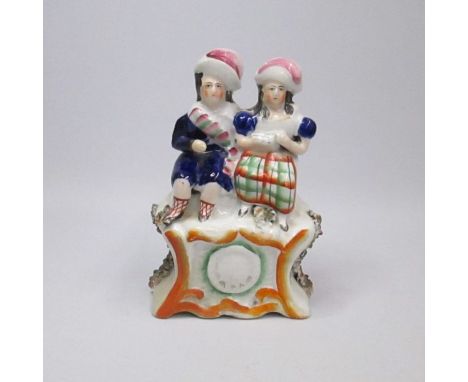A Staffordshire figure of a Clock groupCirca: 1855Size: 16cm HCondition: Old restoration to boy's right arm and corner of the