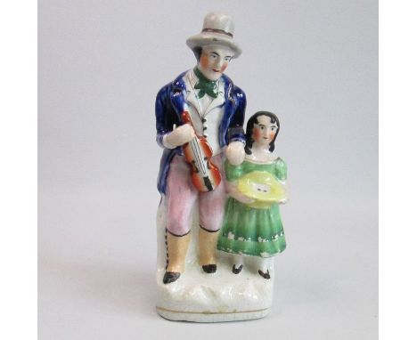 A Staffordshire Alpha factory figure of a musician with a young girlCirca: 1847Size: 21cm HCondition: Chip to the hat rim, en