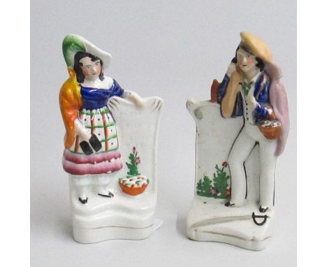 A pair of Staffordshire Crimean war figures of a soldier’s wife leaning on a gravestone, and a sailor leaning on a gravestone