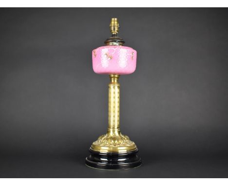 A Late Victorian Brass Based Oil Lamp with Pink Opaque Glass Reservoir Decorated with Flowers, Converted to Electricity, 50cm