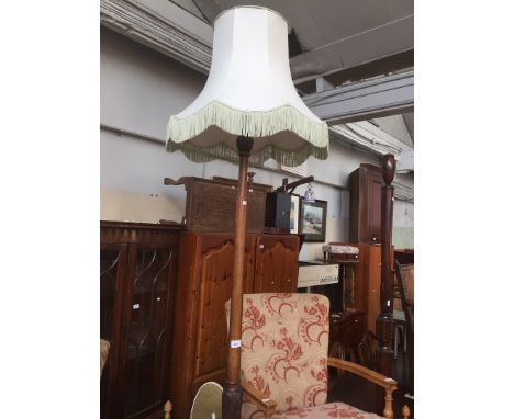 A 1930s mahogany standard lamp with shade, height approx. 182cm. 