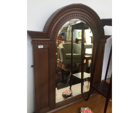 A large architectural oak framed mirror circa 1920s with domed top, dentilated mouldings, domed and bevelled mirror with pane