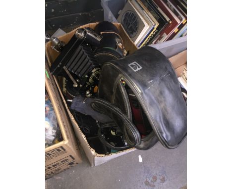 A box of cameras, accessories, lenses, tripods, etc to include Yashika FR1, Voightlander, Praktica, Polaroid, Kodak Brownie f