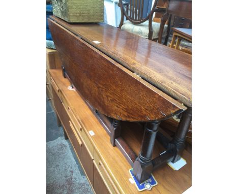 An aged oak gate leg coffee table in the manner of Titchmarsh and Goodwin, length 147cm, min. depth 35cm &amp; height 50cm. 