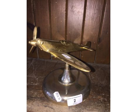 A solid brass model of a Spitfire plane 