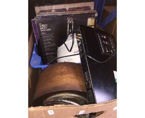 A box of misc to include LPs, a helmet, a mantel clock and a DVD player 