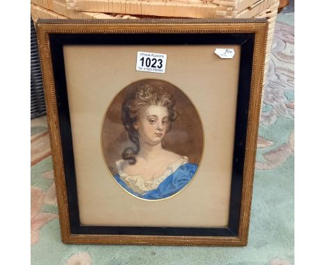 A framed and glazed portrait in watercolour.