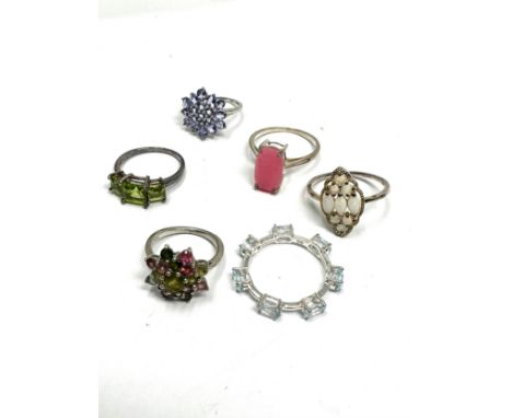 Six silver stone set rings including opal and tanzanite (17g) 
