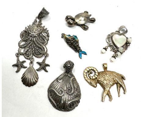 Six silver pendants including an enamel lucky fish (39g) 