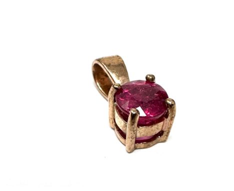 9ct gold ruby pendant measures approx 1.4cm drop by .5 cm wide weight1.1g 
