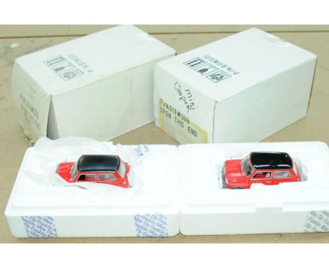 Franklin Mint - a boxed pair of 1:24th Scale Morris Mini Coopers comprising of B11WS08. Conditions are generally Good (unchec